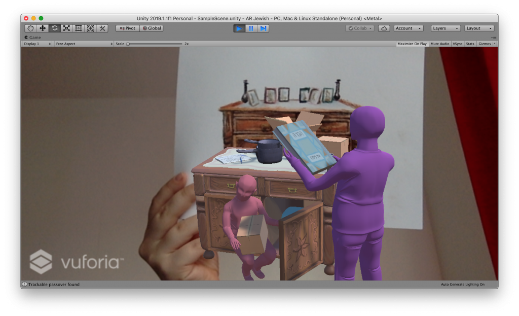 A screencap of an augmented reality scene running in the game engine Unity with the software Vuforia™. It shows how when a drawing of a cabinet is held up to the camera, a textured 3D model pops up with the same cabinet. Here the father and the child are unpacking boxes with kitchen utensils. The father holds a book with Hebrew writing that says "Hagadah".